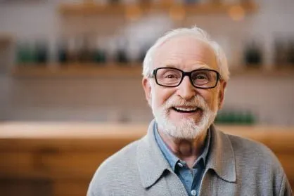 Image of a smiling older man with glasses